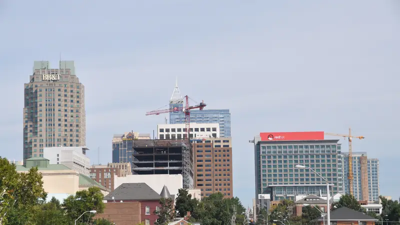 Downtown Raleigh skyline seen from a tree-lined street